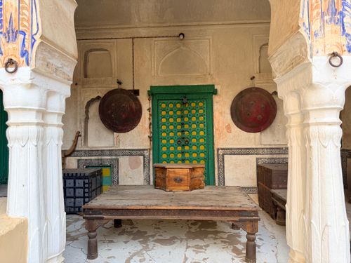 Free Discover the traditional architecture of a Mandawa haveli with an ornate green door and historical decor pieces. Stock Photo
