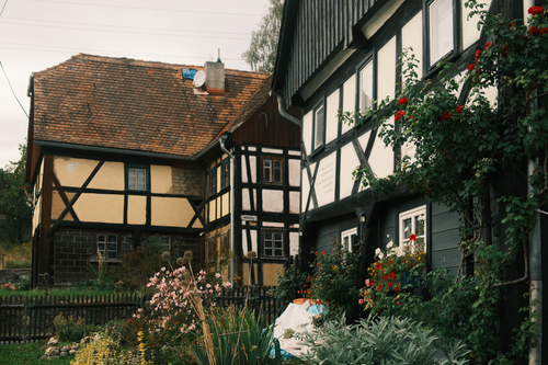 Free Picturesque half-timbered houses with vibrant gardens in Dittersdorf, Thüringen, Germany. Stock Photo