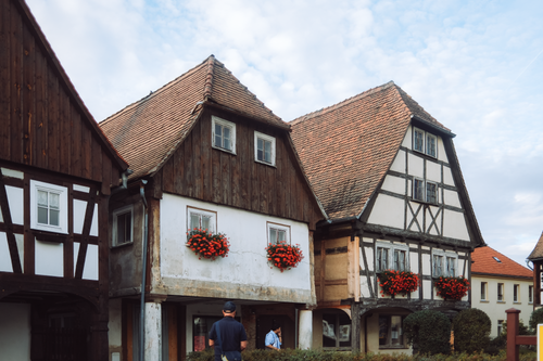 Free Traditional half-timbered houses in Dittersdorf, Thuringia, Germany, under a bright sky. Stock Photo