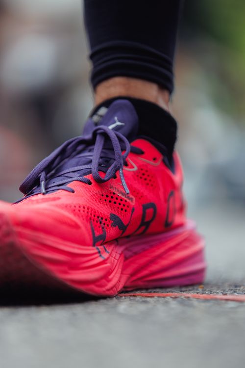Free Vibrant running shoe on pavement, signaling start of a race in Colombia. Stock Photo