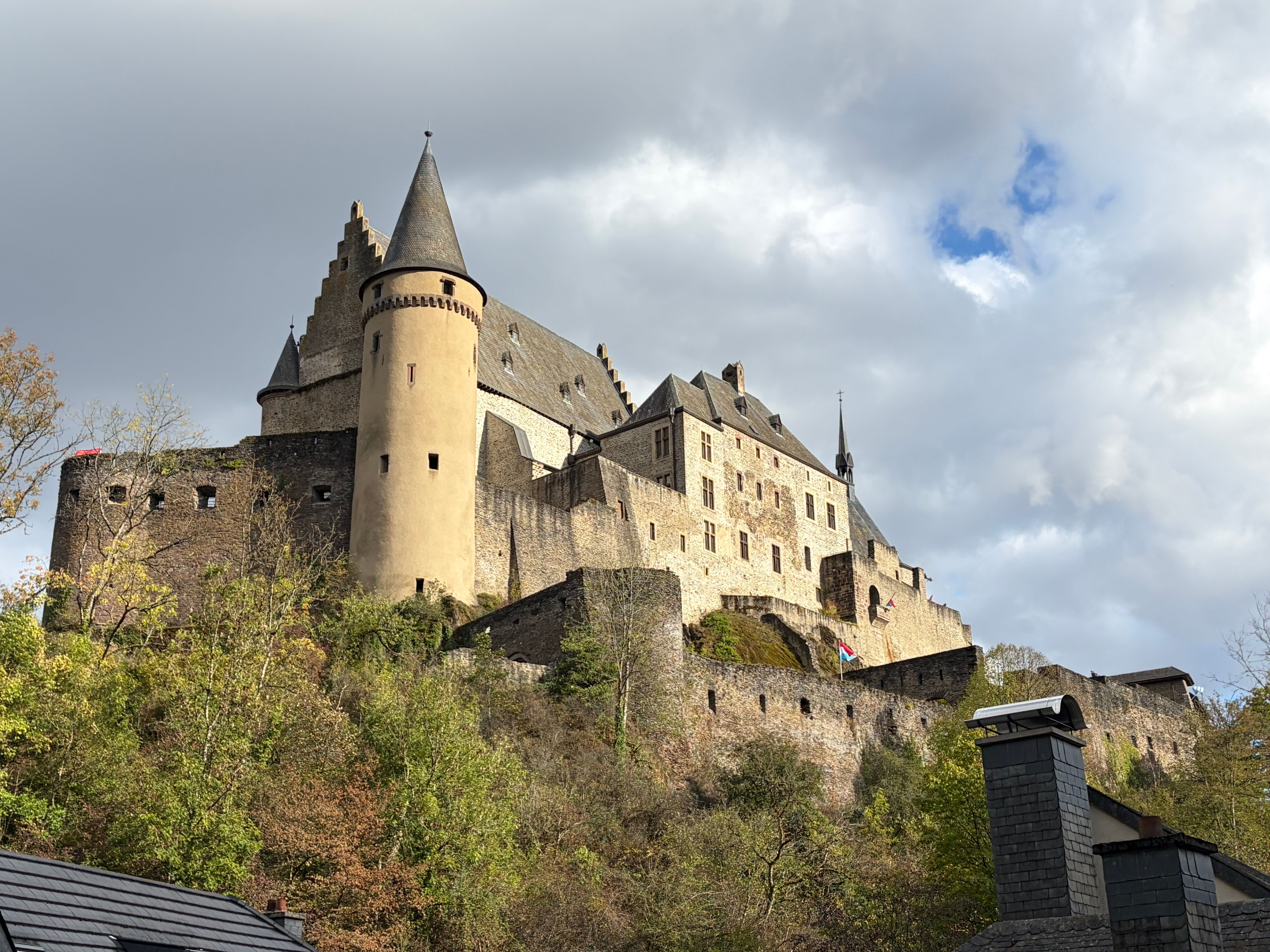 Vianden Castle towering against a cloudy sky in Luxembourg.
