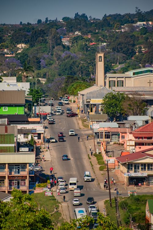 Free A vibrant urban scene depicting a busy street in Manzini, Eswatini with cars and pedestrians. Stock Photo