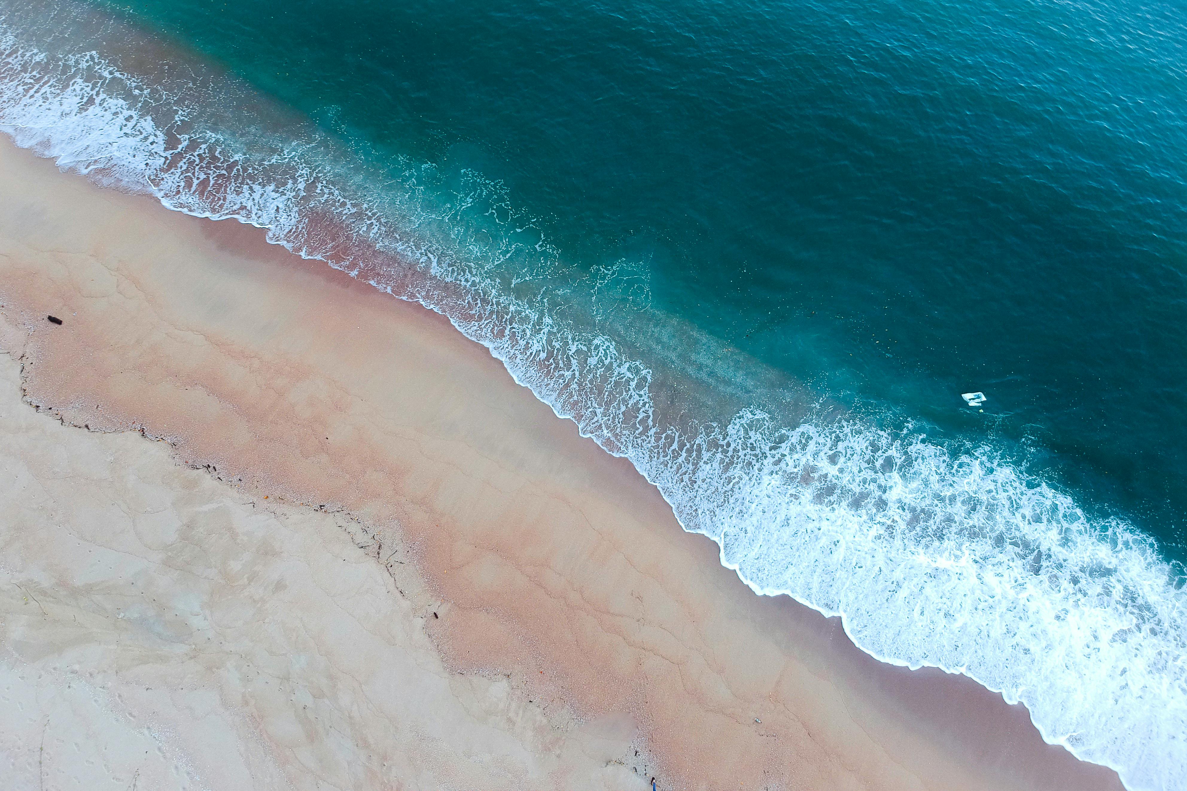Aerial Shot Of Ocean Waves On Shore · Free Stock Photo