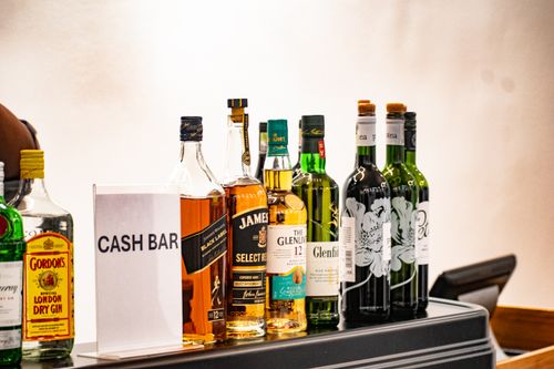 Free A variety of liquor bottles displayed at a cash bar, ideal for events. Stock Photo