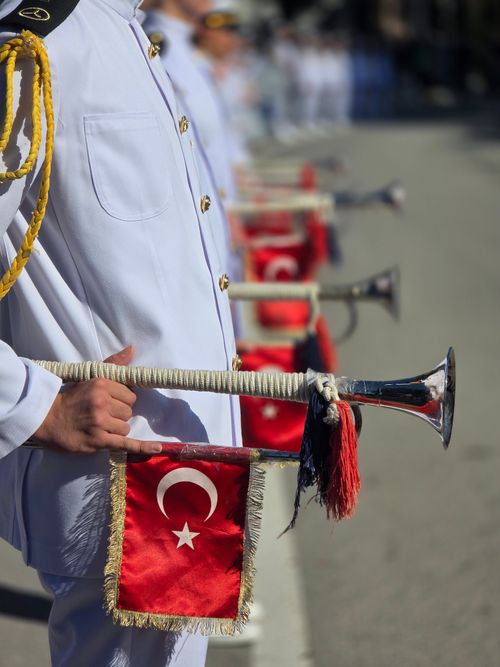 Free Turkish military band members holding brass instruments adorned with national flags during a parade. Stock Photo