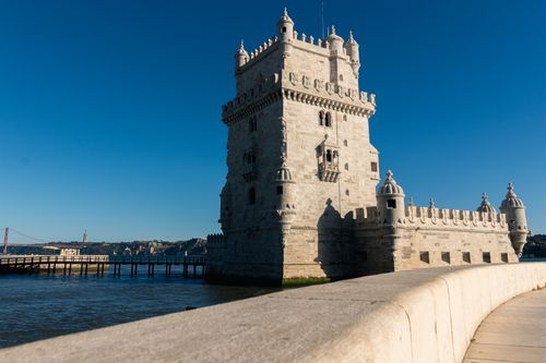 Free View of the historic Belem Tower in Lisbon, Portugal against a clear blue sky, a symbol of Portuguese maritime history. Stock Photo