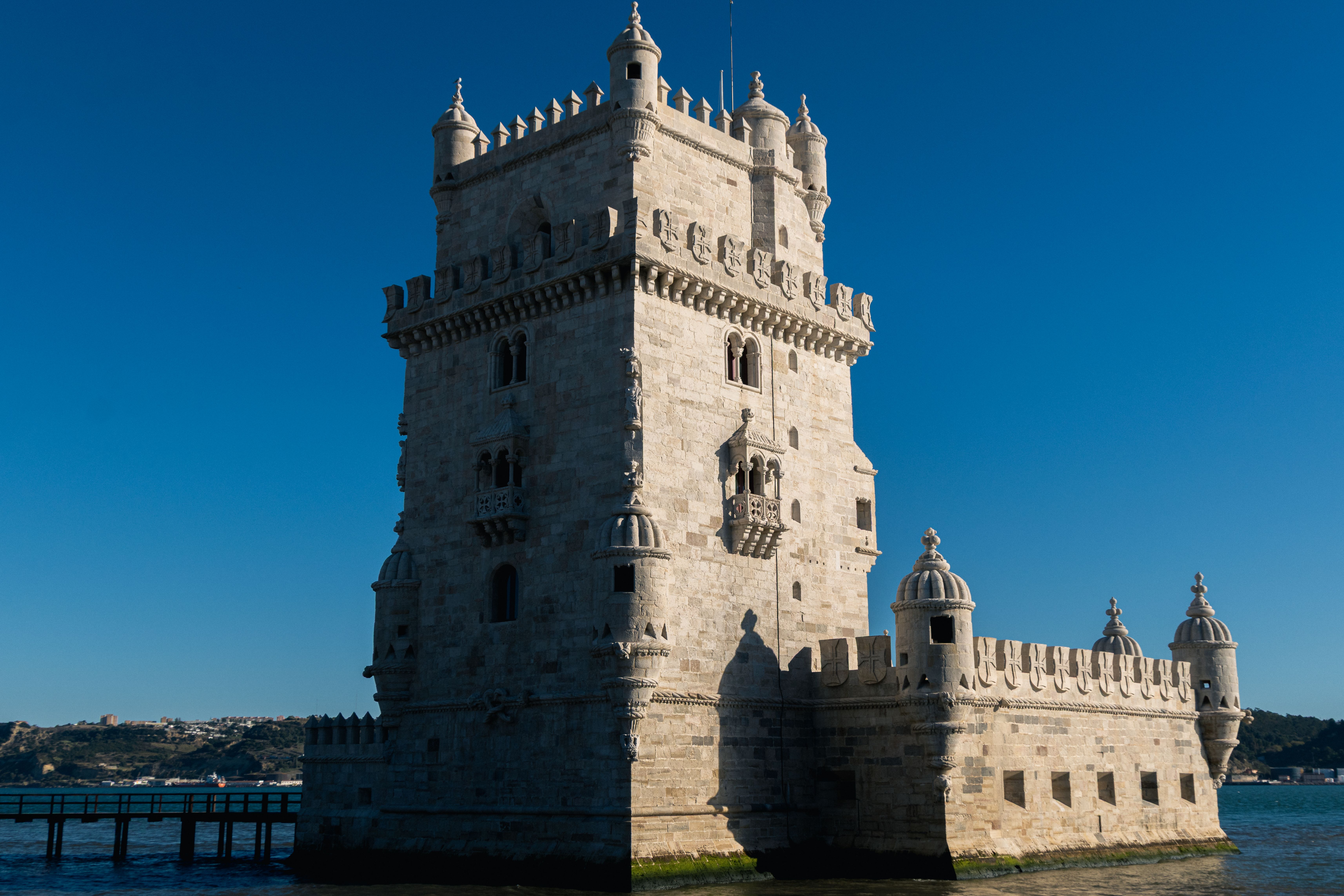 A striking view of the historic Belem Tower in Lisbon, Portugal under a clear blue sky.