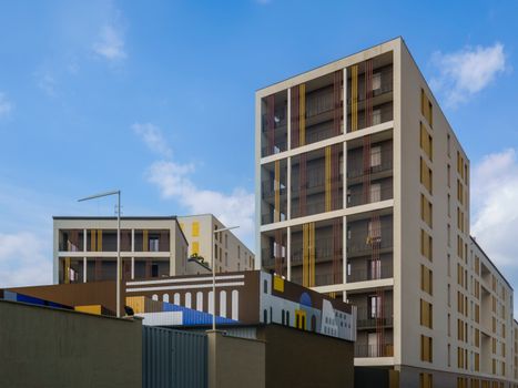 Contemporary urban architecture featuring modern apartment buildings under a clear blue sky.