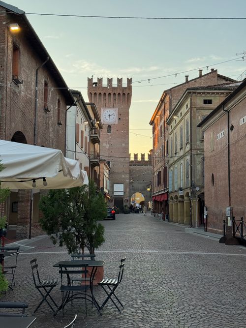 Free A picturesque street in Spilamberto, Italy, showcasing historic architecture and a tower at dusk. Stock Photo
