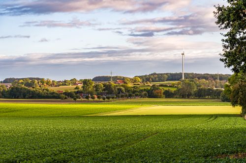 Free Vibrant rural scene in Coesfeld, Germany with fields and wind turbines under a dynamic sky. Stock Photo