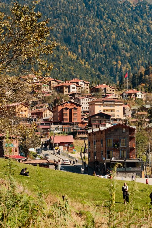 Free Scenic mountain village with colorful houses and lush greenery in autumn. Stock Photo