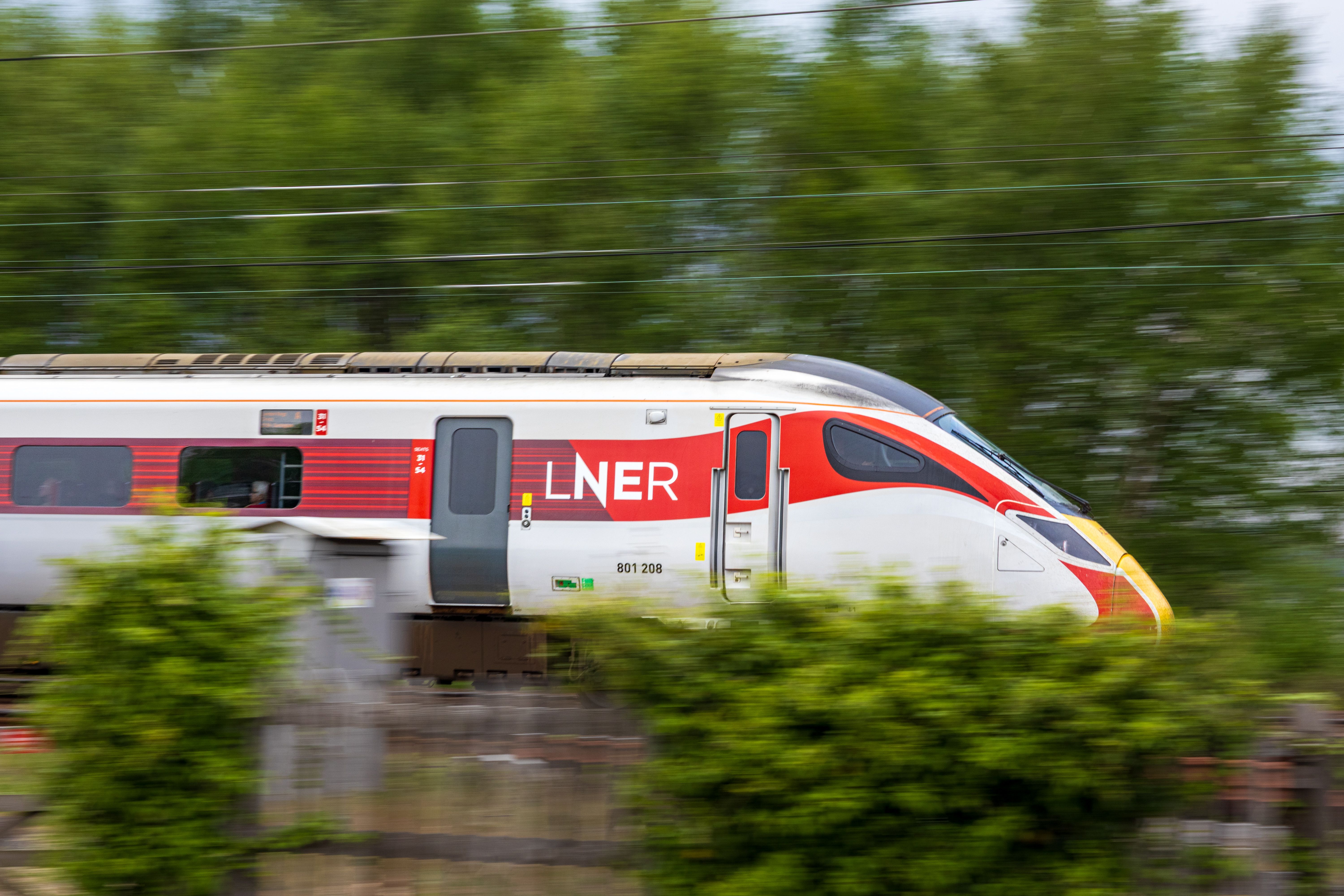 LNER train speeding through a green landscape