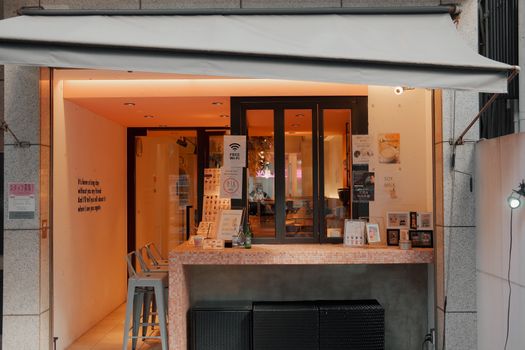 A cozy Japanese café with warm lighting and inviting counter, perfect for a relaxing visit.