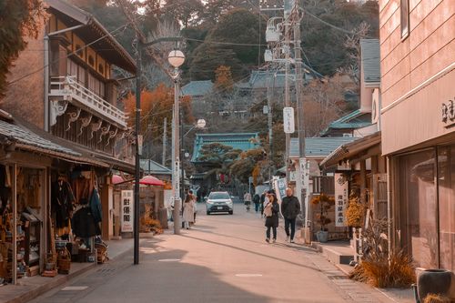 Free Explore a tranquil Japanese street lined with traditional shops and architecture. Stock Photo