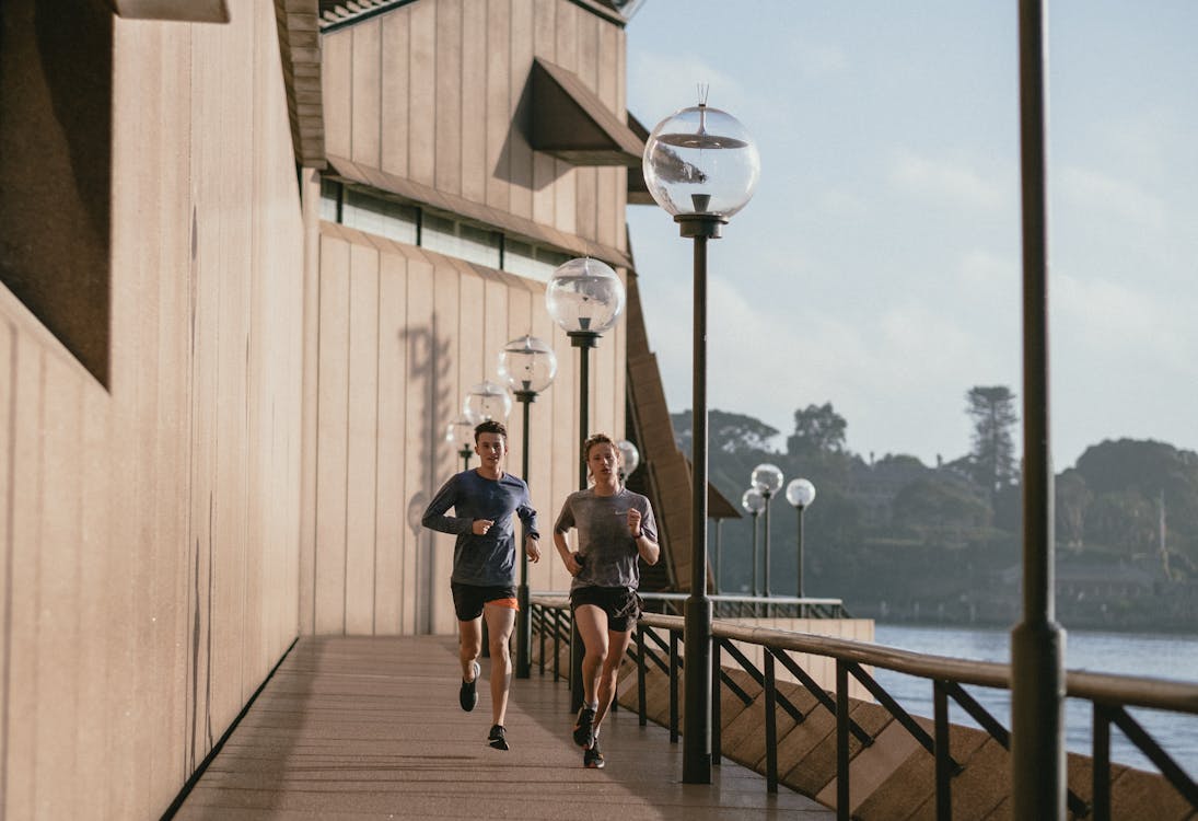 A man and a woman jogging outdoors