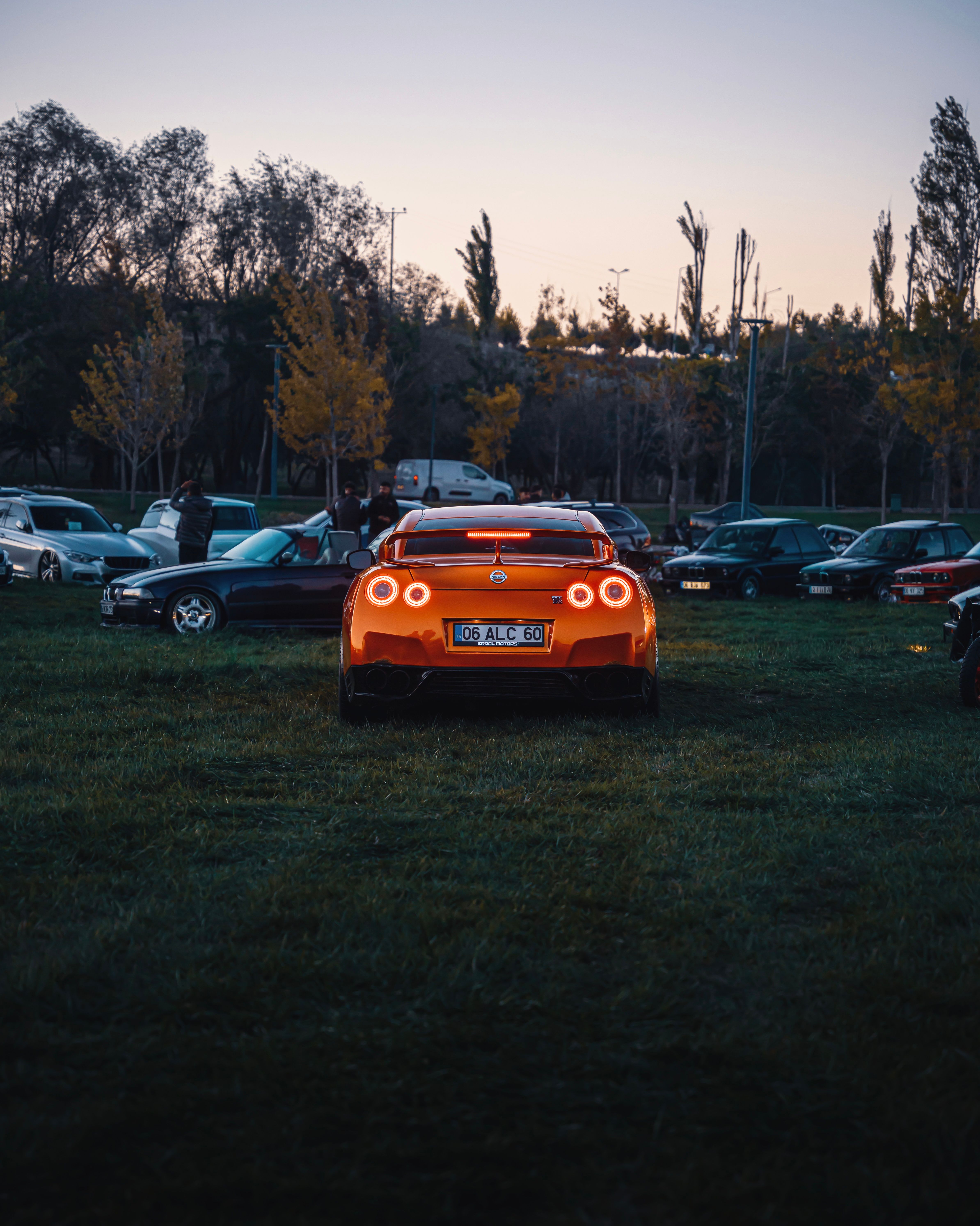 Vibrant Orange Car at Evening Gathering in Ankara · Free Stock Photo