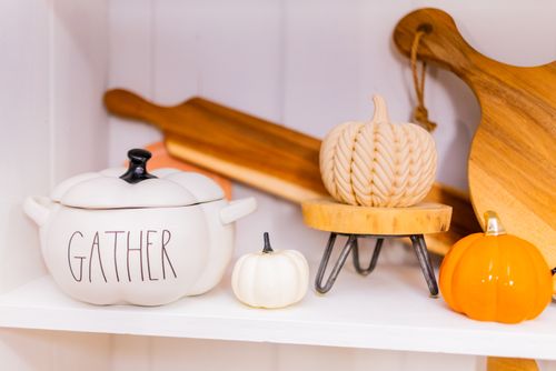 Free Warm and inviting autumn-themed kitchen decor featuring pumpkins and a 'Gather' pot. Stock Photo