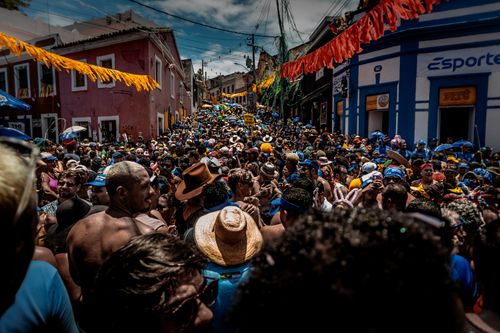 Free A bustling street party in Rio de Janeiro with colorful decorations and a lively crowd of festival-goers. Stock Photo