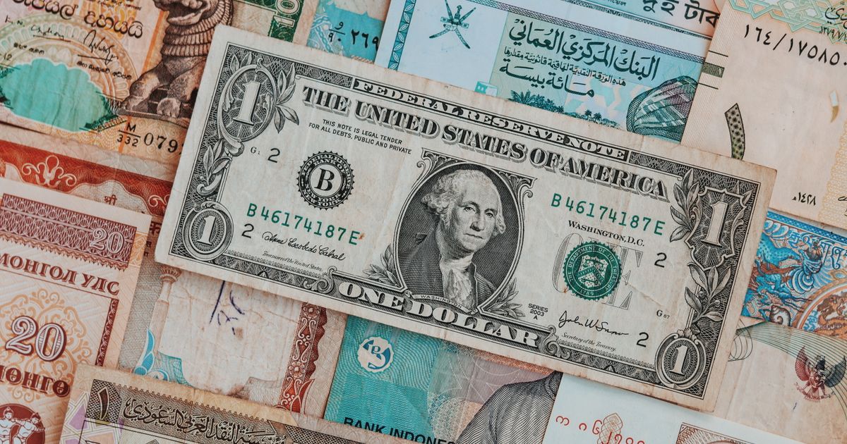 A mix of world currency banknotes representing the strongest currency in the world