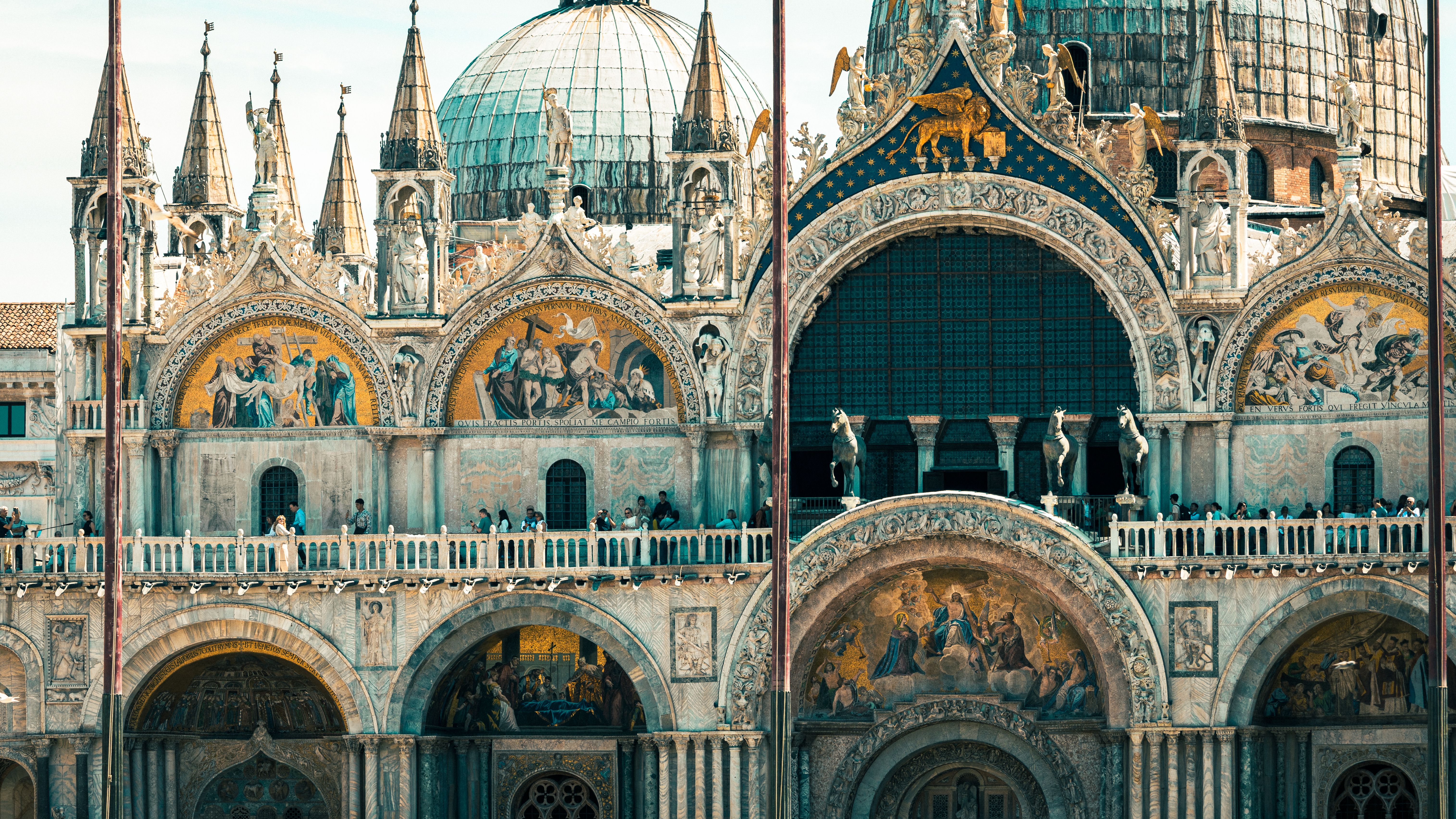 Detailed view of the ornate facade of Saint Mark's Basilica, showcasing Byzantine architecture in Venice, Italy.