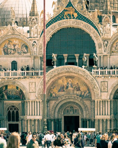 Free Front view of Saint Mark's Basilica with bustling crowds in Venice, Italy, showcasing Byzantine architecture. Stock Photo