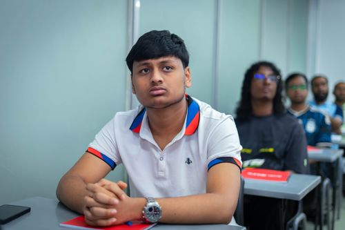 Free Students attentively listening in a classroom setting, focusing on educational learning, captured indoors. Stock Photo