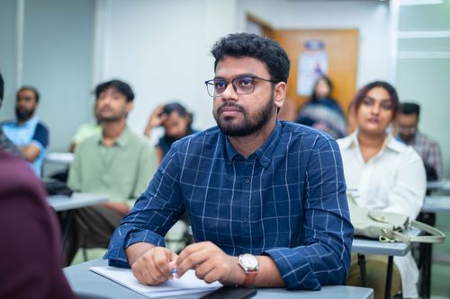 Free Focused students in a classroom, illustrating concentration and learning. Stock Photo
