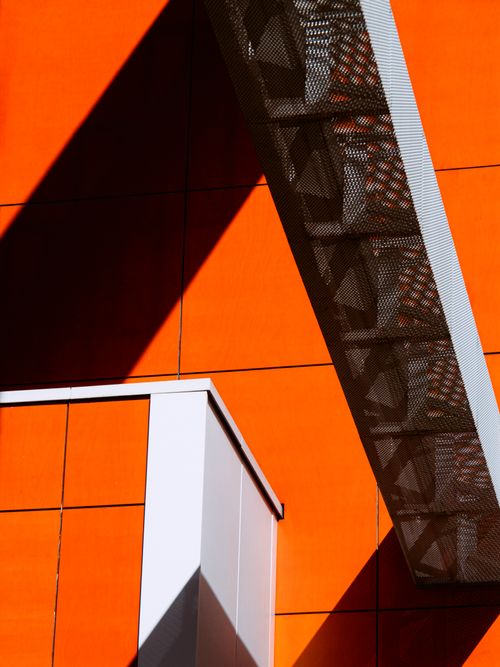Free Dynamic abstract of orange and white modern architecture in Amsterdam with strong shadows. Stock Photo