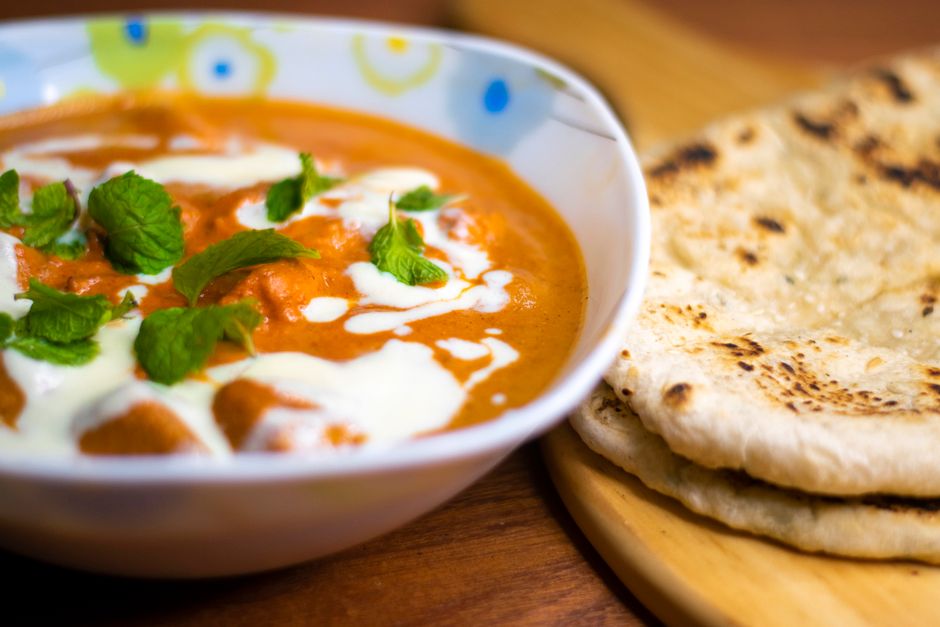 Photo by Mohammad Fahim on Pexels Delicious Indian butter chicken served with naan bread, garnished with fresh mint leaves. - Photo by Mohammad Fahim on Pexels