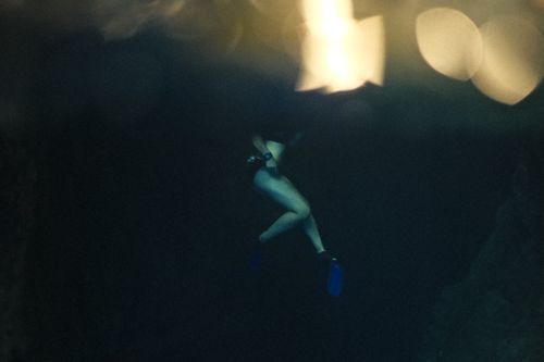 Free Artistic shot of a diver underwater, showcasing legs and blue flippers. Stock Photo