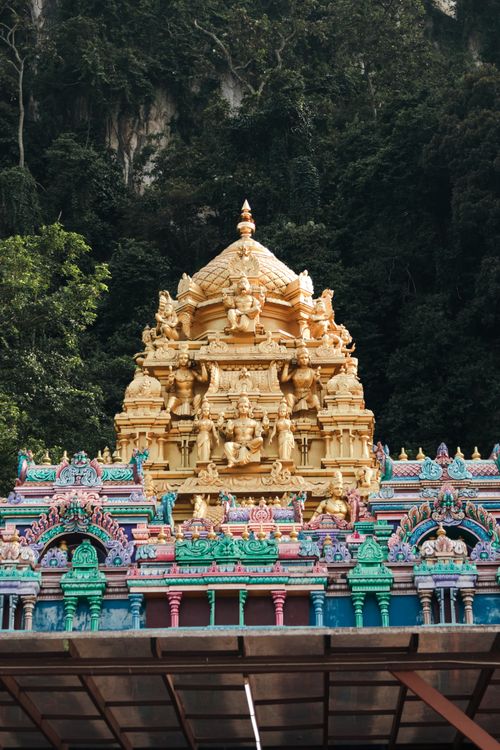 Free Colorful Hindu temple architecture at Batu Caves, Malaysia, set against lush greenery. Stock Photo
