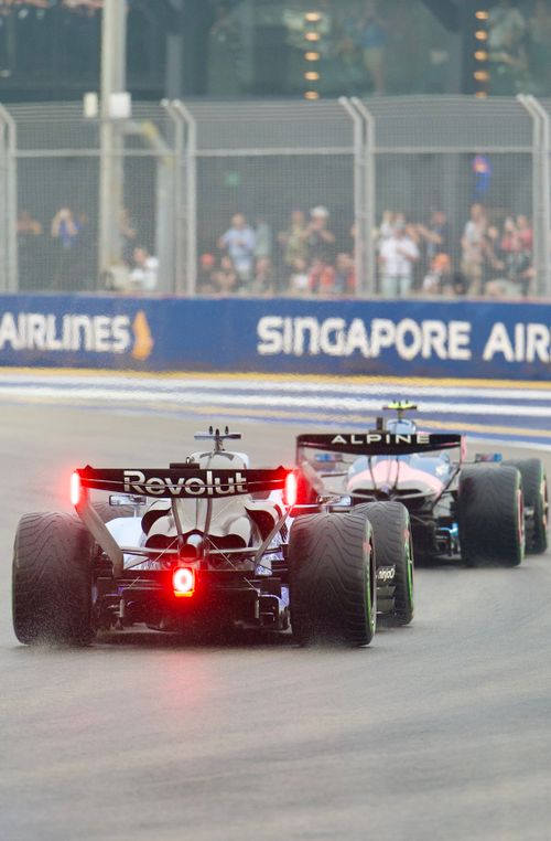 Free Exciting rear view of F1 cars racing at the Singapore Grand Prix track. Stock Photo