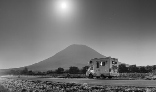 Free A camper van under the moonlit sky by Mount Yotei, Japan, showcasing night camping adventure. Stock Photo