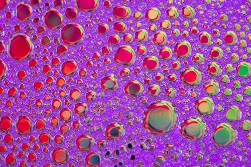 Free Vivid and colorful soap bubbles forming an abstract art pattern with vibrant reflections and textures. Stock Photo