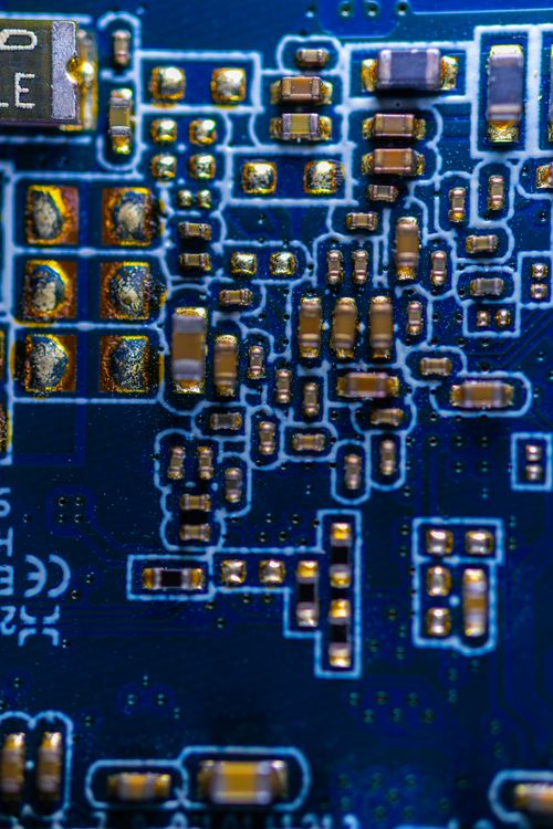 Free Detailed macro photograph of a blue circuit board showing electronic components. Stock Photo