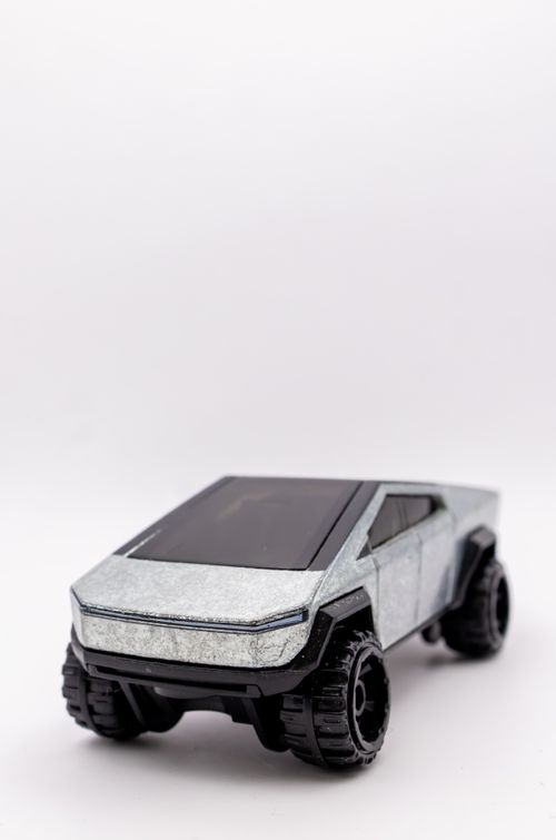 Free A futuristic toy truck with a sleek metallic design on a white backdrop. Stock Photo