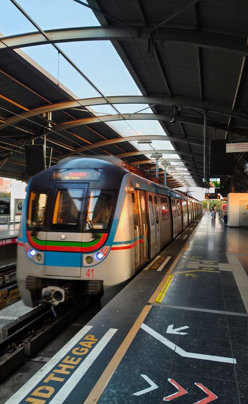 Free Hyderabad Metro train arriving at a modern station platform during the day. Stock Photo