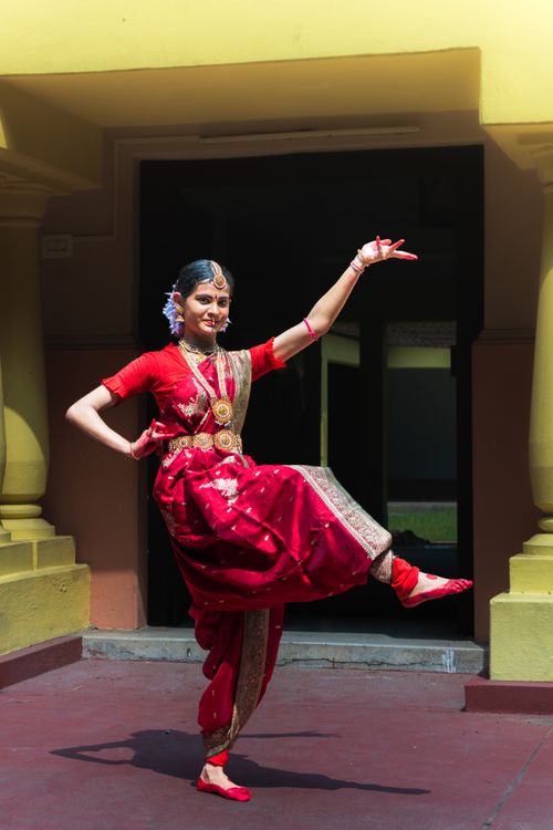 Free A woman performing Indian classical dance in vibrant attire at a historic site. Stock Photo