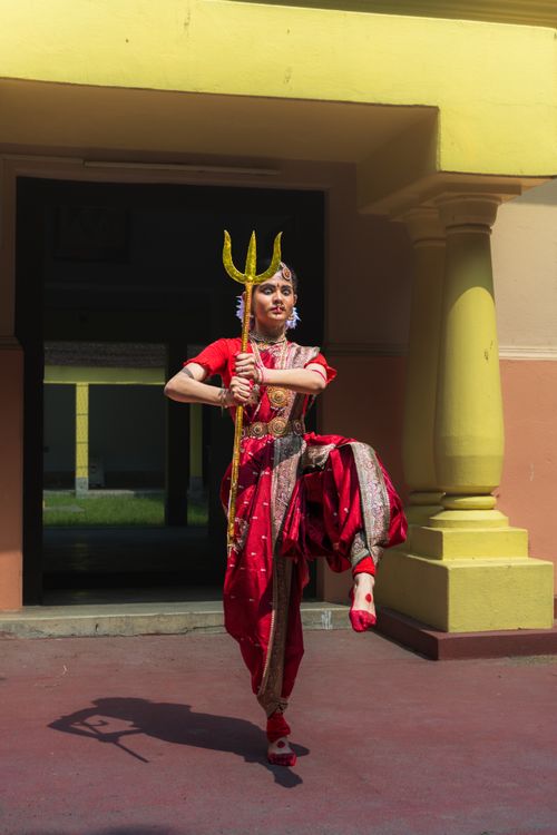 Free A vibrant Indian dancer in traditional attire performs with a trident in Purulia, WB, India. Stock Photo