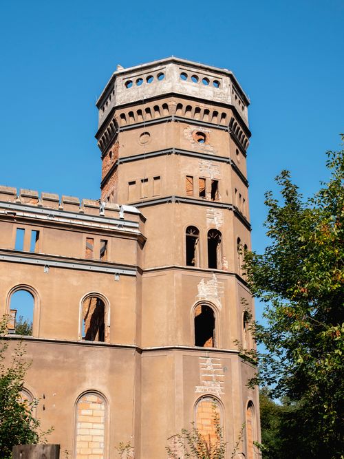 Free A historic tower ruin in Wrocław, showcasing architectural decay against a clear blue sky. Stock Photo