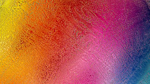 Free Colorful abstract texture featuring a blend of vivid rainbow hues creating an artistic visual effect. Stock Photo