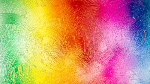 Free Colorful abstract background with vibrant brush strokes in a rainbow gradient pattern. Stock Photo
