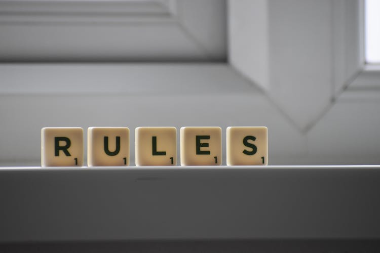 Similar Cubes With RULES Inscription On Windowsill In Building