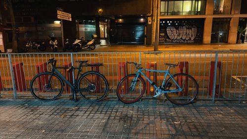 Free Two bicycles parked on a Barcelona street at night, showcasing urban nightlife. Stock Photo