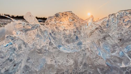 Free Close-up of melting ice in the Baltic Sea reflecting a beautiful sunset, captured in early spring. Stock Photo