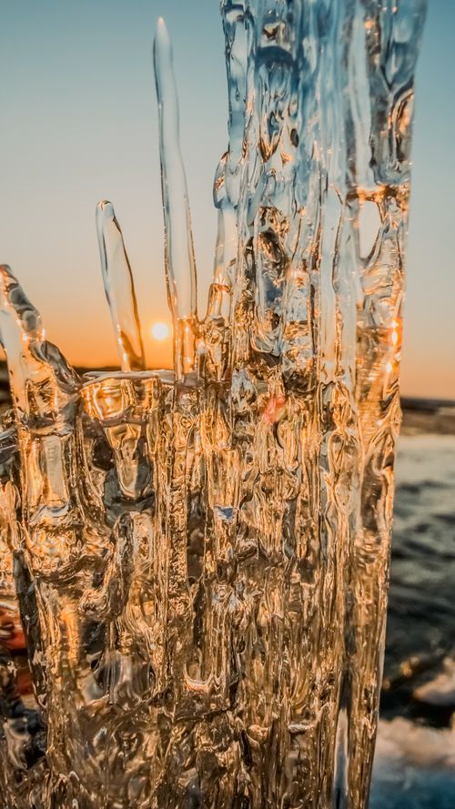 Free Stunning ice formations captured against a vibrant sunset sky, showcasing natural beauty. Stock Photo
