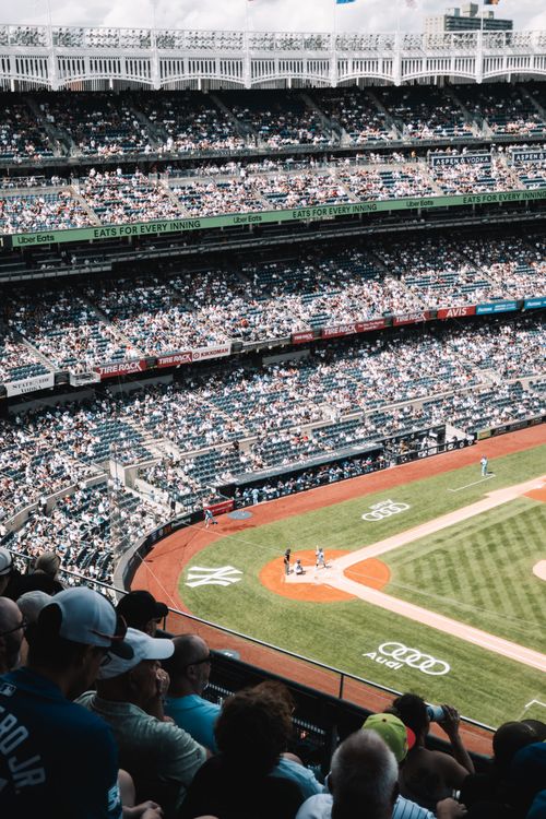 Free High-angle view of a baseball game in a packed stadium, showcasing team spirit and excitement. Stock Photo