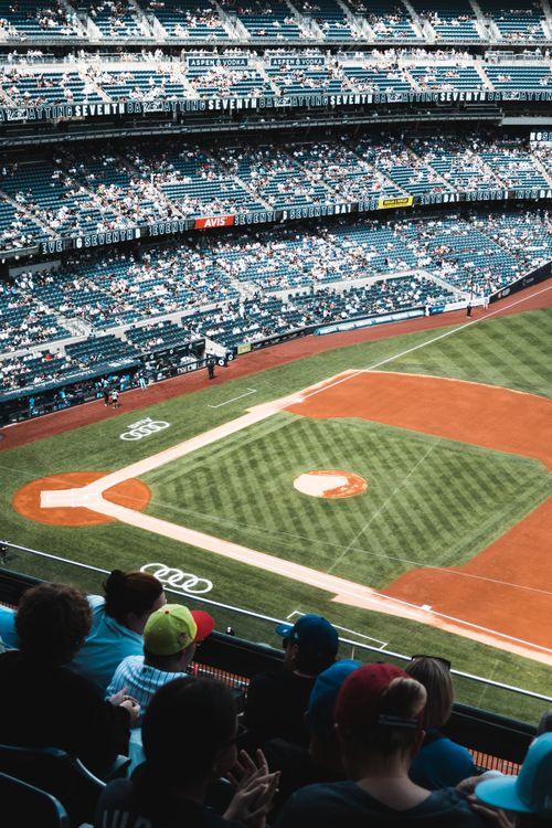 Free A lively baseball game unfolds at a large stadium filled with spectators enjoying the sport. Stock Photo