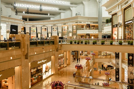 Contemporary design of big mall interior with ribbed column and decorative elements on ceiling with glowing corridors illuminated by artificial lights and signboards with inscriptions