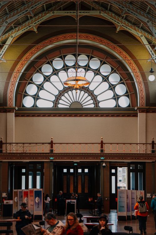 Free A beautiful interior with arched windows and people in a New Zealand atrium. Stock Photo